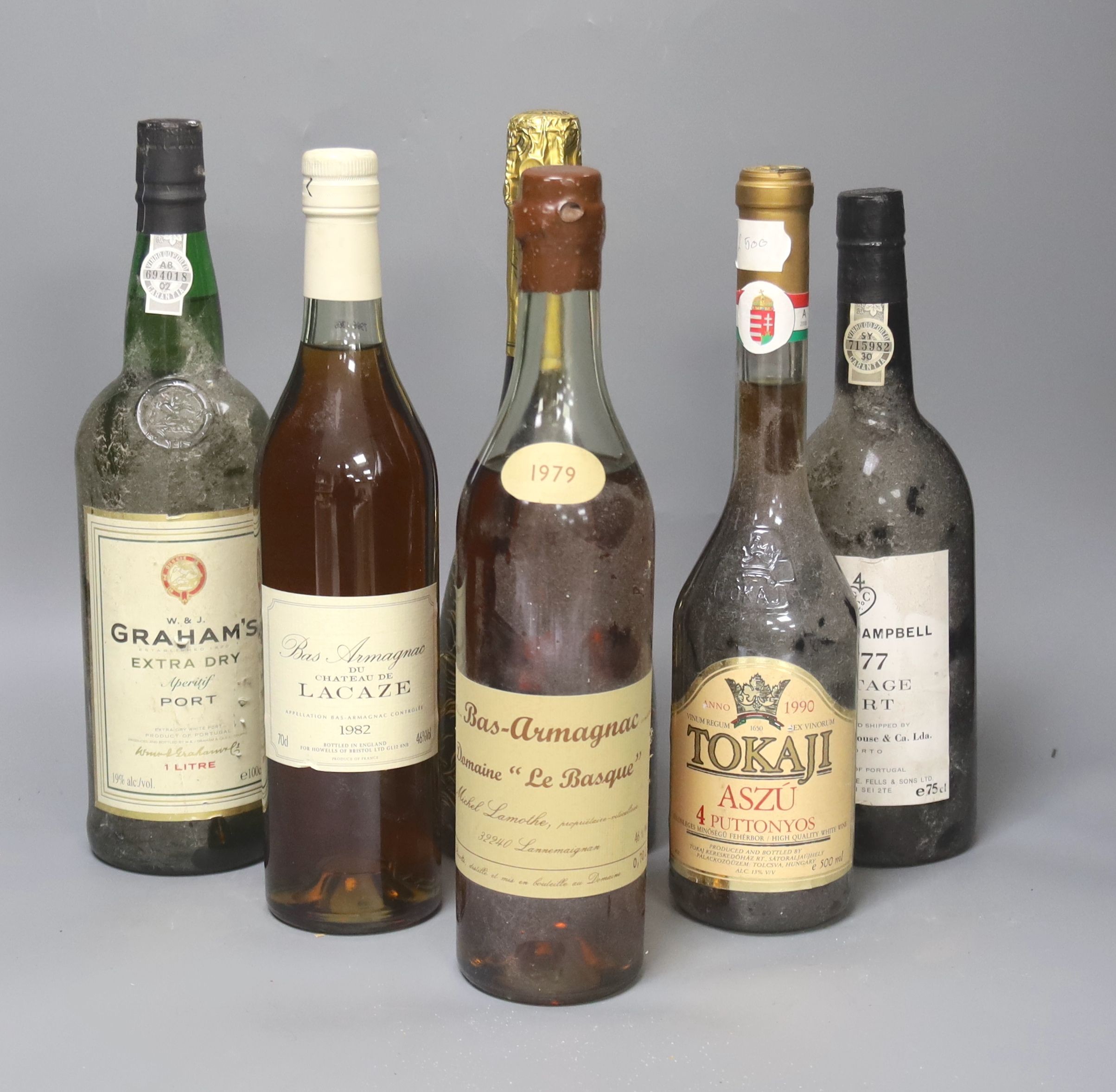 One bottle of Gould Campbell 1977 Vintage Port, one Domaine Le Basque Armagnac 1979, one Chateau de Lacaze Armagnac, 1982, one Tokaji, 1990, one Graham's Extra Dry Port and one Duvall Leroy 2000 Champagne.